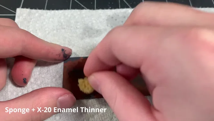 Soak an artist sponge in enamel thinner, and stipple it over the dark rust wash to break up the color and create texture.