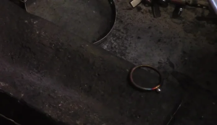 Attach the ball: Place the ball onto the ring where the solder joint is located. Apply more solder paste to the connection point. Heat the entire ring evenly to attach the ball, ensuring the solder flows and secures it to the band. Quench in water.