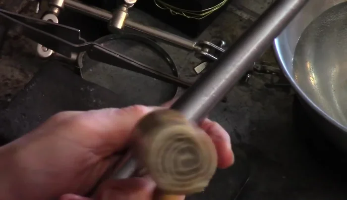 Shape and size the ring: Use a ring mandrel and a mallet (rawhide for preventing marks, ball-peen for texture) to shape and size the ring. For sizing up, use the mallet and angle it slightly while gently tapping, gradually moving it down the mandrel.