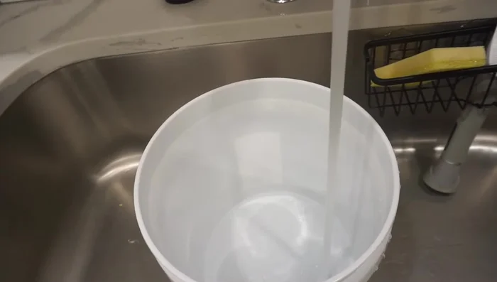 Mix Mod Podge and water: Create a glue mixture by combining Mod Podge and water in a bucket.