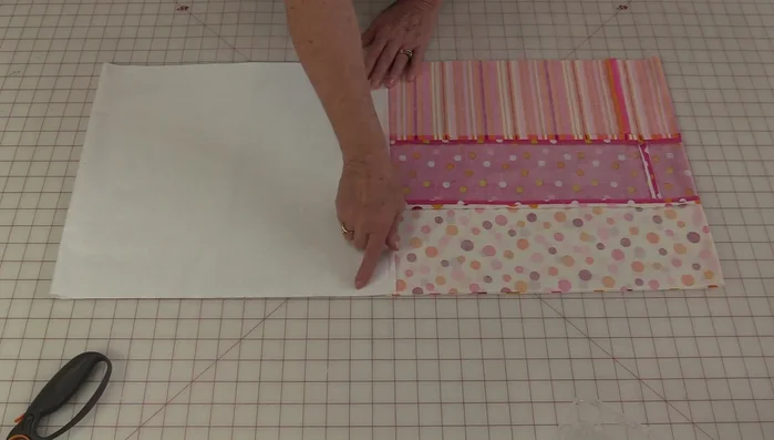 Stitch along the marked lines to create casings, leaving small openings on both sides for turning and inserting the drawstring.