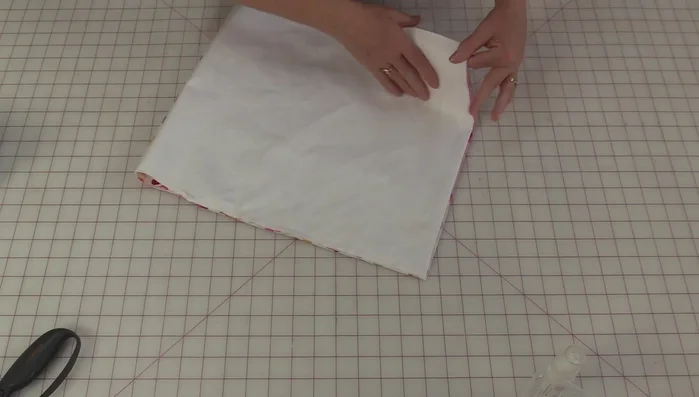 Create square corners (optional): Fold the bag in half twice, cut a small square out of each corner, and stitch the seam closed.