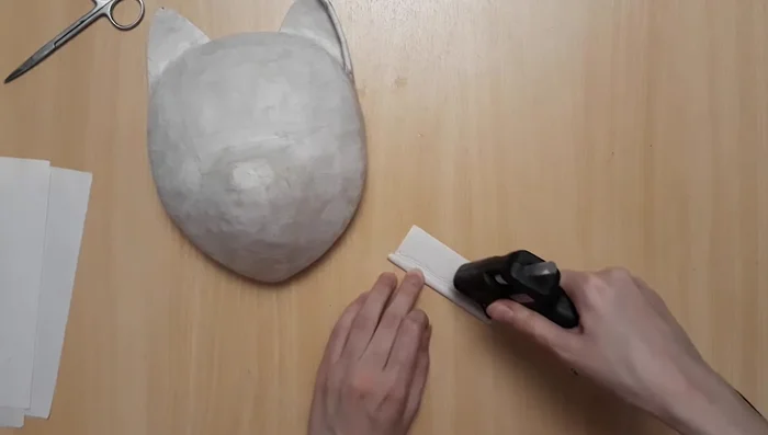 Adding details to the ears and forehead using paper and paper mache.