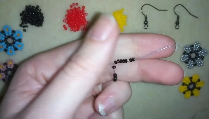 Create a circle of 12 black seed beads.