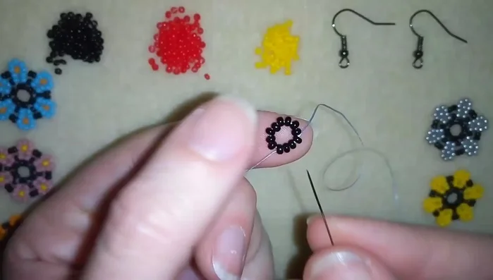 Repeat step 2, creating more petal shapes around the black bead circle.