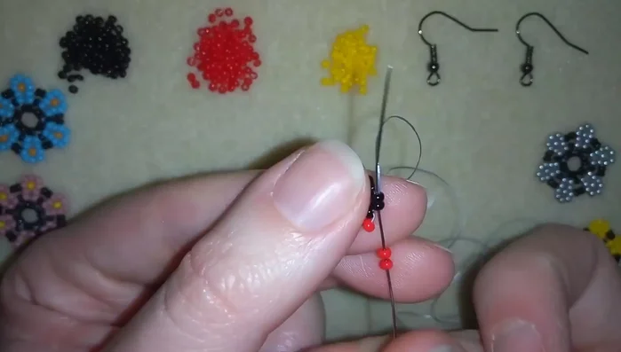 Repeat step 2, creating more petal shapes around the black bead circle.