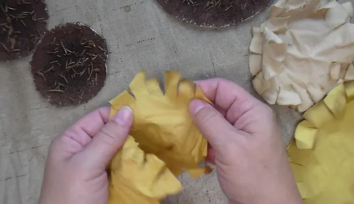 Stuff the sunflower, sew the opening closed, and optionally attach a stick for hanging.