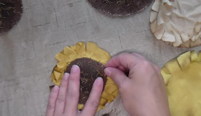 Stuff the sunflower, sew the opening closed, and optionally attach a stick for hanging.