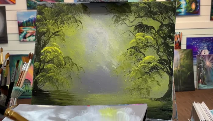 Use the angle brush (slightly wet with white) to create hazy waterfalls in the background with subtle, scumbled strokes. Vary the width of the strokes by turning the brush.