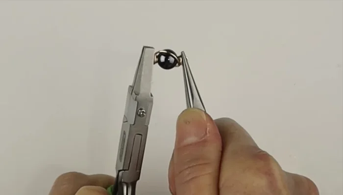 Straighten out the loops using flat pliers.