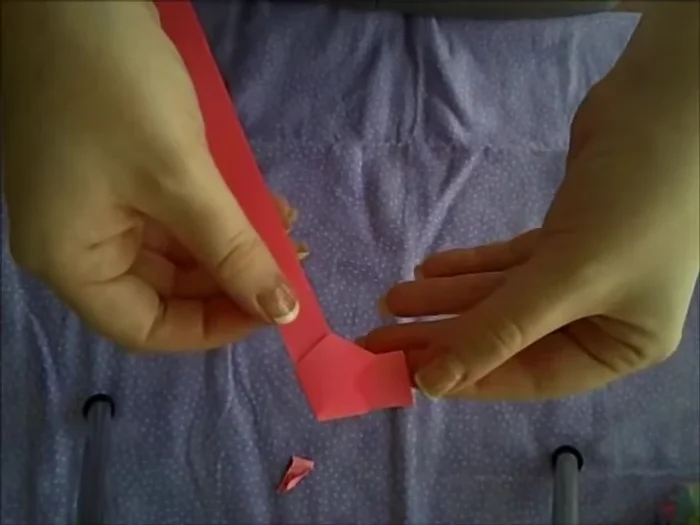 Tuck the extra flap under to create a pentagon shape.