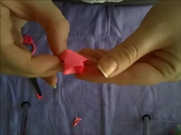 Pinch the sides of the pentagon and gently push inward to make the star pop up.