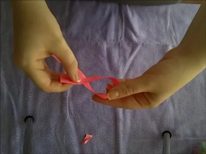 Tie a knot in the paper strip, creating a loop.