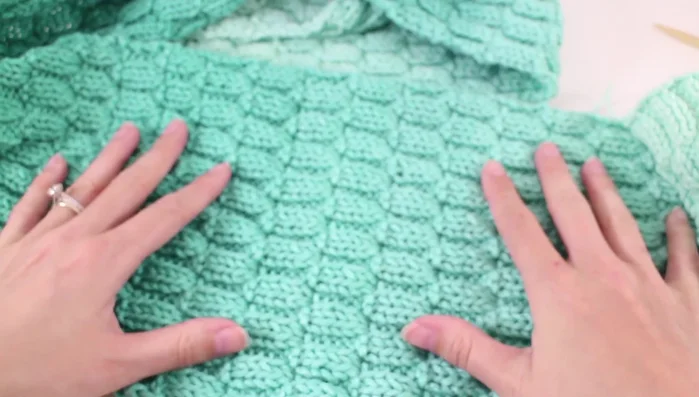 Wet block the scarf to relax the fibers and even out the stitch pattern.