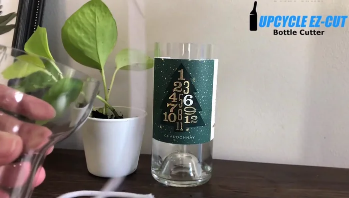 Thread the string through the hole in the wine bottle's top, allowing the string to hang down inside.