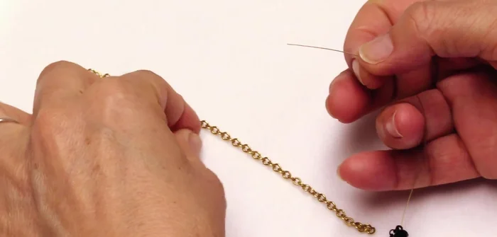 Crimp and secure one end: Attach a 2mm crimping bead, thread protector, and crimp the bead using crimping pliers. Add a 3mm crimp cover.