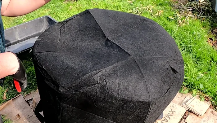 Prepare the fabric pot: Cut drainage holes in the bottom of the fabric pot. Optional: Cut away handles if desired.