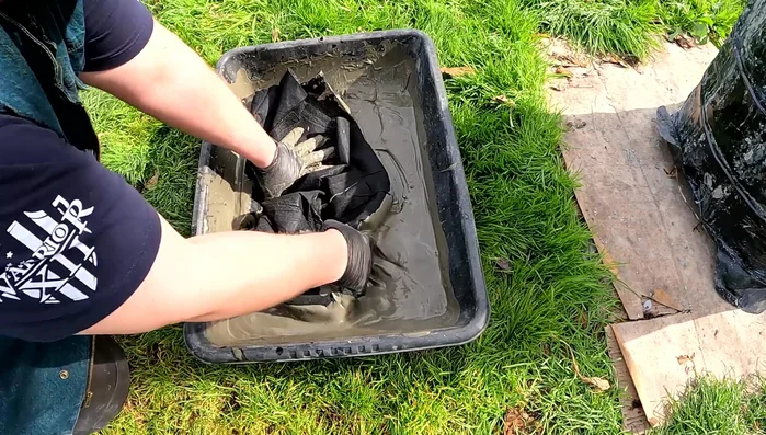 Soak the fabric pot: Completely soak the fabric pot with the cement mixture. Use your hands to work the cement into the fabric, especially the inside. 