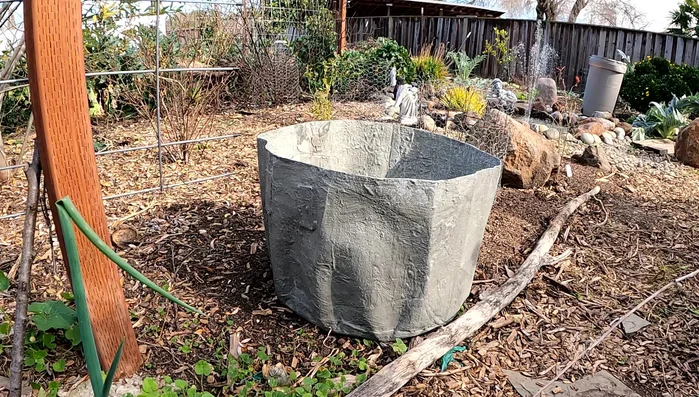 Remove and fill: After 24 hours, remove the dried concrete pot from the mold. Fill with potting mix.