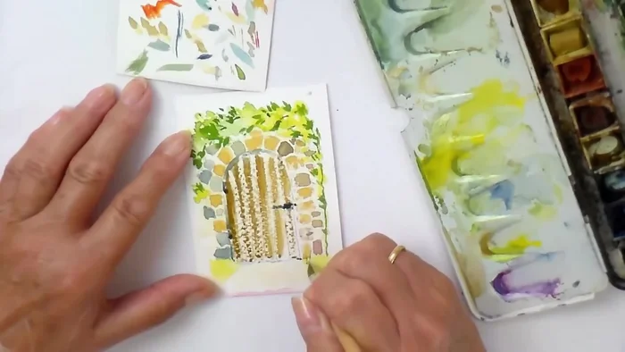 Apply wax resist to the right-hand side of each plank of the gate to create a wood grain effect.