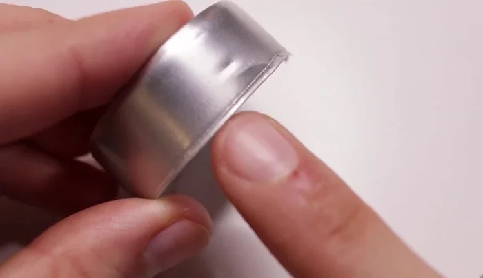 Clamp: Create a clamp from aluminum from a tea light and a small oval ring of wire. Paint and glue to the canister.