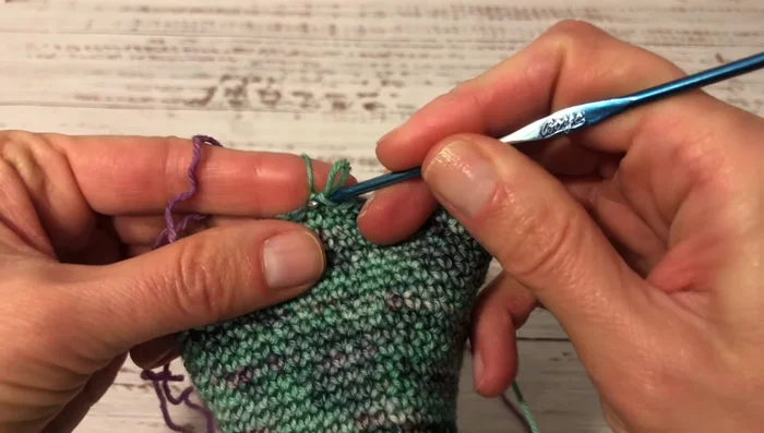 Slip stitch, turn. Crochet single crochet into each of the next ten stitches. Repeat until all side stitches are joined to the central ten stitches.