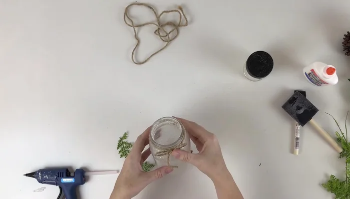 Glue the swag to the front of the jar.