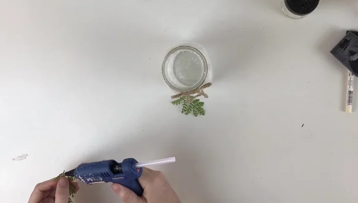 Glue the greens together to form the swag and add red berries to the center.