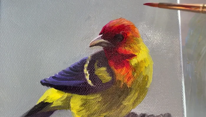 Add highlights to the bird's head using a mix of vermilion, permanent orange, and white.