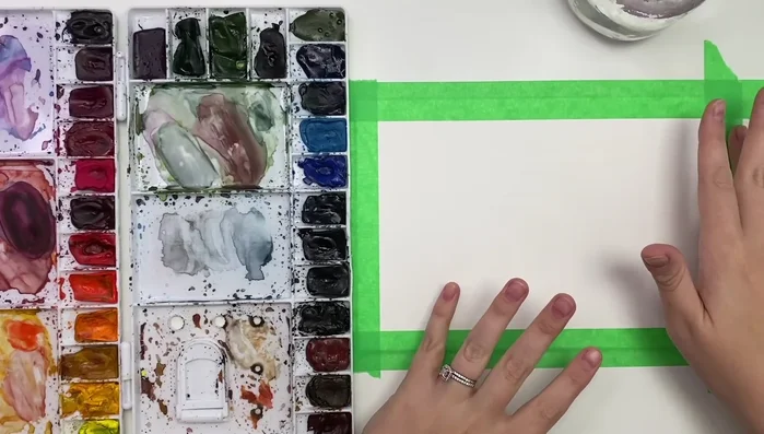 Prepare your workspace: Tape watercolor paper to a board (or table).