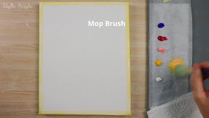 Apply cadmium yellow deep, light pink, and white to the edges of the canvas using a soft fluffy brush.