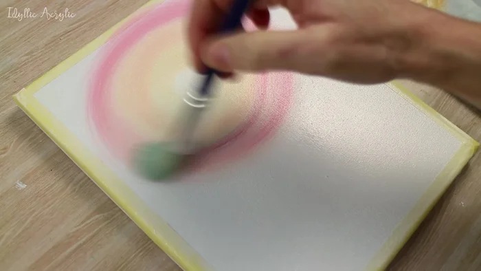 Create a purple-blue color by mixing ultramarine, pink, and a touch of white; use this to paint around the sunrise area and soften the edges.