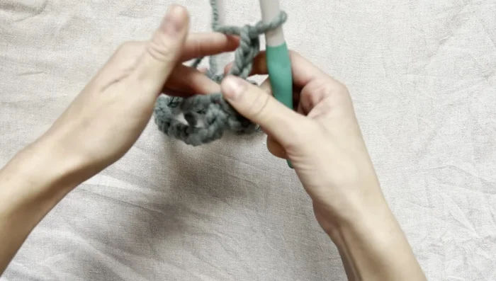 Continue this pattern (double crochet in each space, (double crochet, chain one, double crochet) in marker spaces) until the desired length for the top of the sweater is reached (approximately to the armpits).