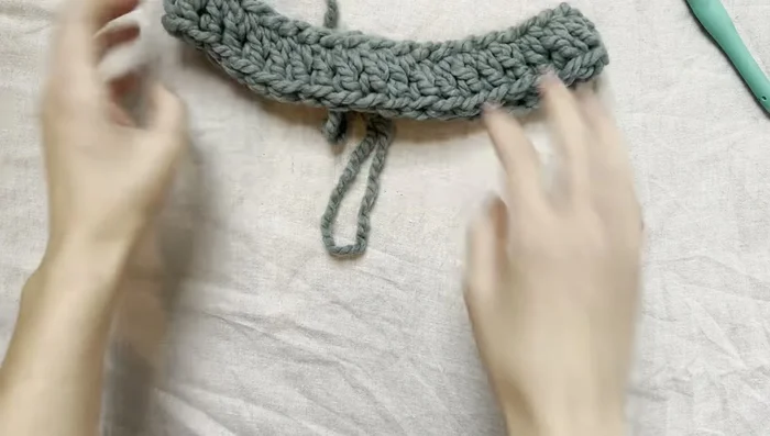 Continue this pattern (double crochet in each space, (double crochet, chain one, double crochet) in marker spaces) until the desired length for the top of the sweater is reached (approximately to the armpits).