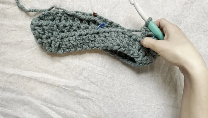 Continue this pattern (double crochet in each space, (double crochet, chain one, double crochet) in marker spaces) until the desired length for the top of the sweater is reached (approximately to the armpits).