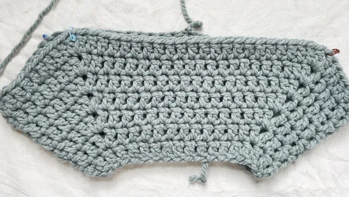 Slip stitch, tie off, and weave in ends. Repeat for the second sleeve.