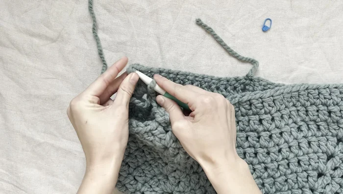 Slip stitch, tie off, and weave in ends. Repeat for the second sleeve.