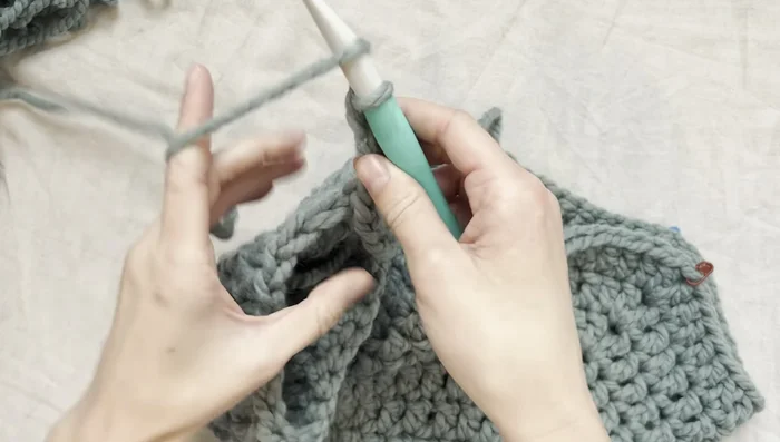 Slip stitch, tie off, and weave in ends. Repeat for the second sleeve.