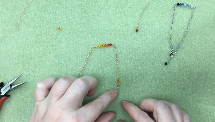 Attach the clasp to one end of the bracelet by creating a loop in the wire and securing it with 3 wraps, ensuring some flexibility for movement.