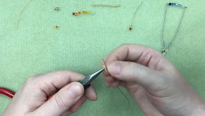 Attach the wire loop to the center of your chain using needle nose pliers for a neater finish. Secure with 3 wraps and trim the excess wire.