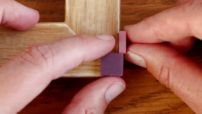 Place tiles randomly but neatly, maintaining even spacing and straight lines. Blend colors seamlessly by adding tiles of the previous color.