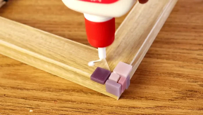 Place tiles randomly but neatly, maintaining even spacing and straight lines. Blend colors seamlessly by adding tiles of the previous color.