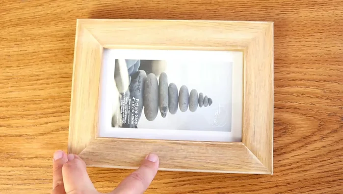 Lightly sand the frame where tiles will be applied. This helps the glue adhere better.