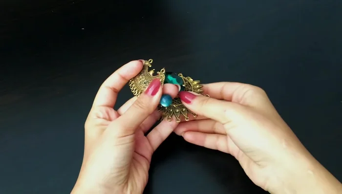 Assemble the main necklace structure: Connect the central and side metal components using pins and beads. The length of the pins and bead sizes need to be adjusted to fit.