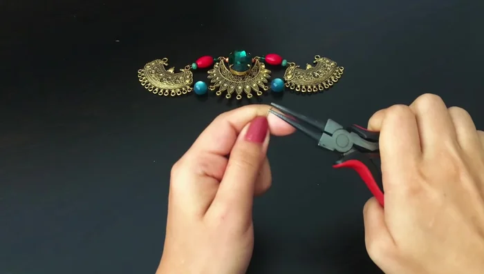 Create the bottom portion: Use memory wire to string rows of beads. Start with brick-colored beads, followed by yellow faceted beads, and continue adding rows of contrasting colored beads.