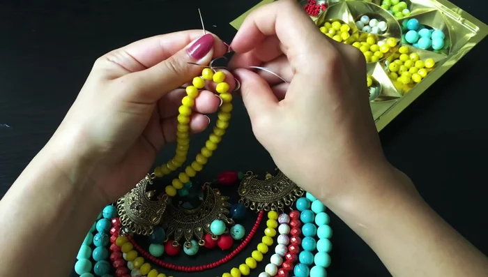 Finish the necklace: Add more beads to the sides and attach a clasp to complete the necklace.