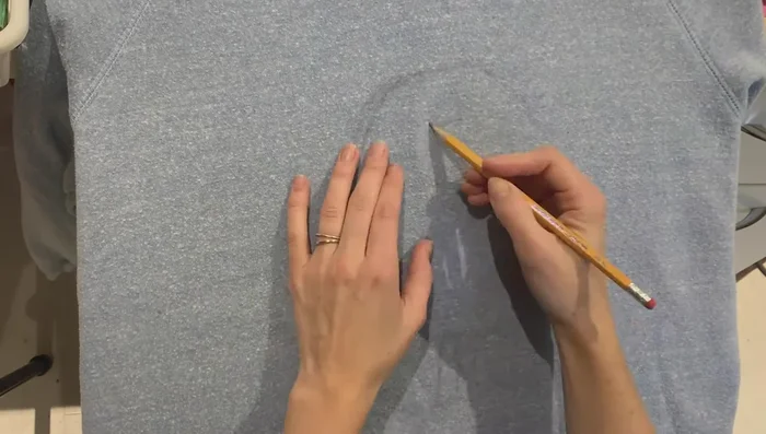 Lightly sketch your design onto the fabric using a pencil (or chalk pastel for delicate fabrics). Don't worry about perfection, just enough to guide your painting.