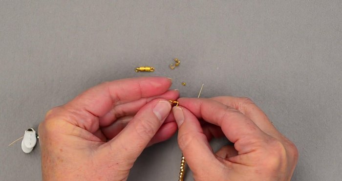 Attach the clasp to the clamshell bead tip.