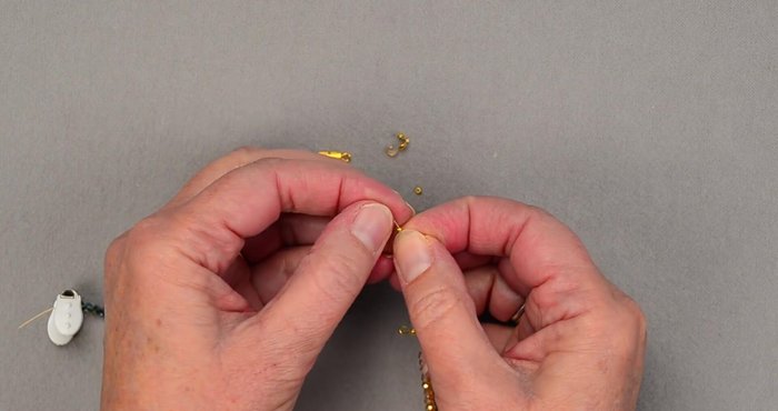 Attach the clasp to the clamshell bead tip.