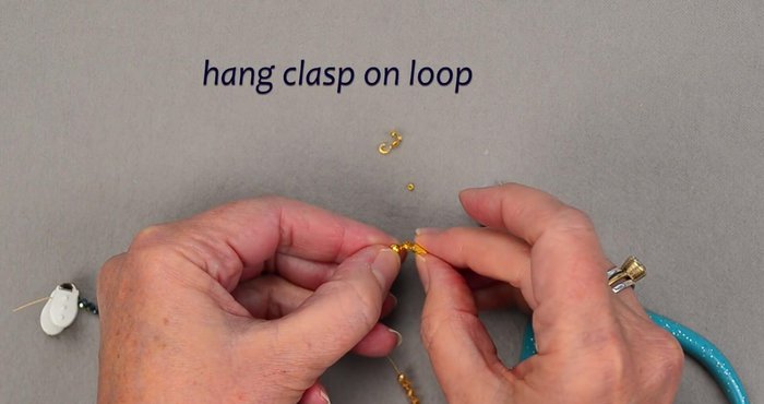 Attach the clasp to the clamshell bead tip.